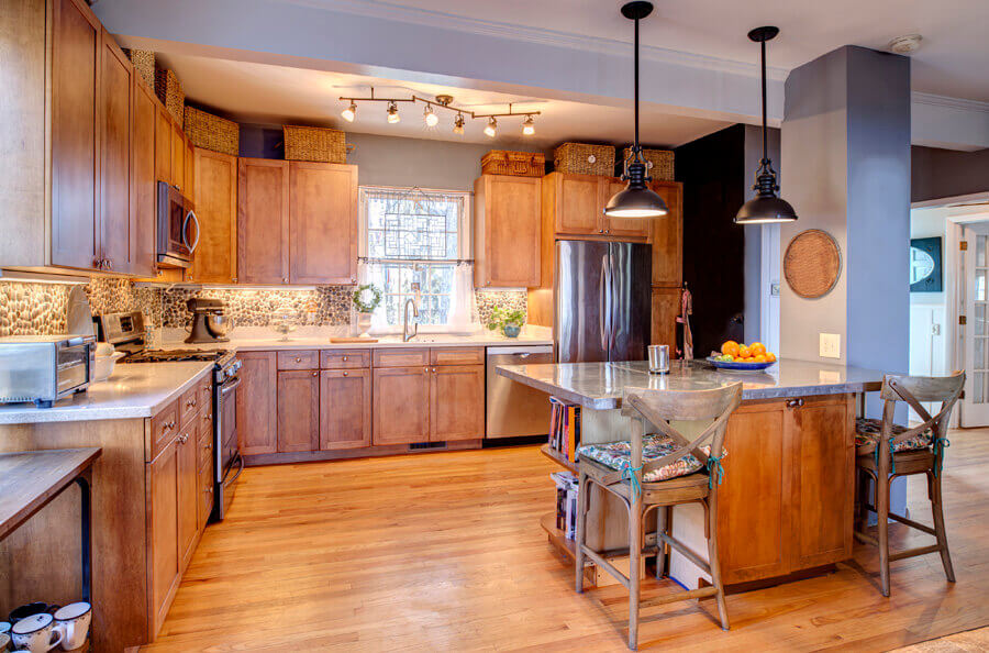 Remodelled kitchen with new cabinets, an island and hardwood flooring